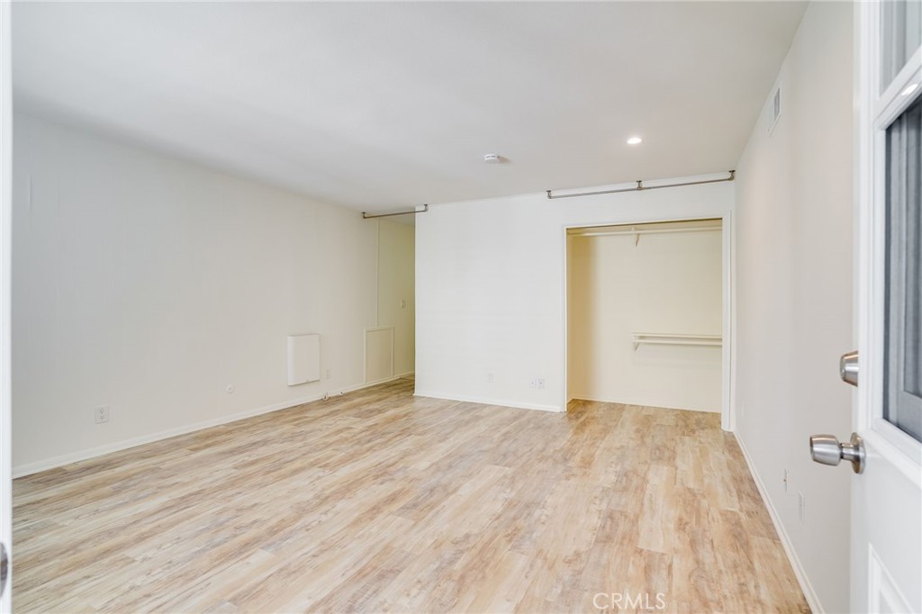 705 Iris Avenue Corona del Mar, CA 92625 - Photo 21 of 36 an empty room with wooden floor and closet