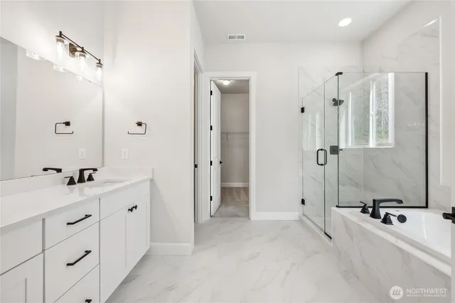 a bathroom with a double vanity sink mirror and shower