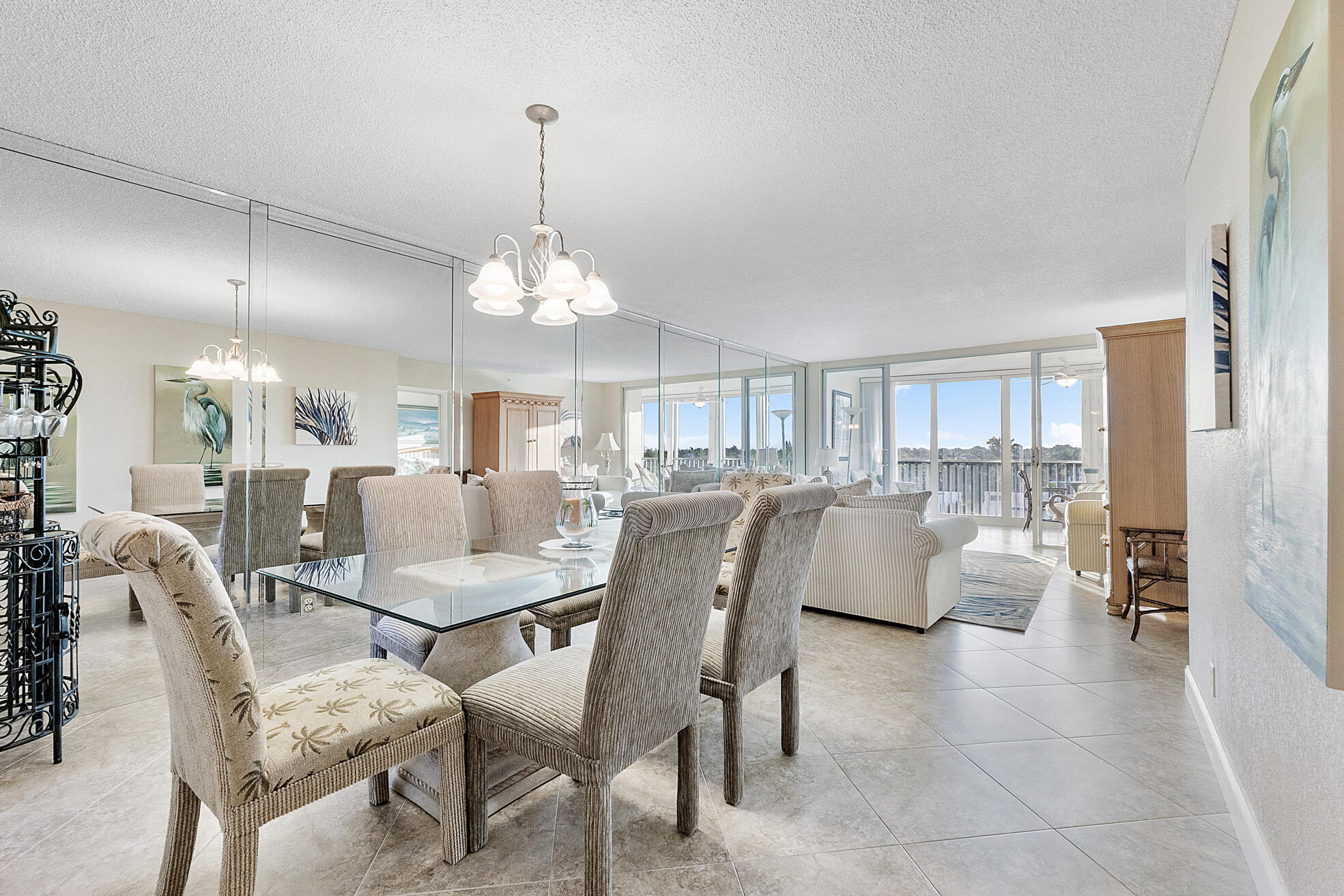 a dining room with furniture a chandelier and wooden floor
