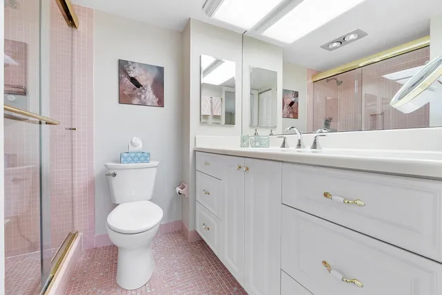 a bathroom with a toilet sink and mirror