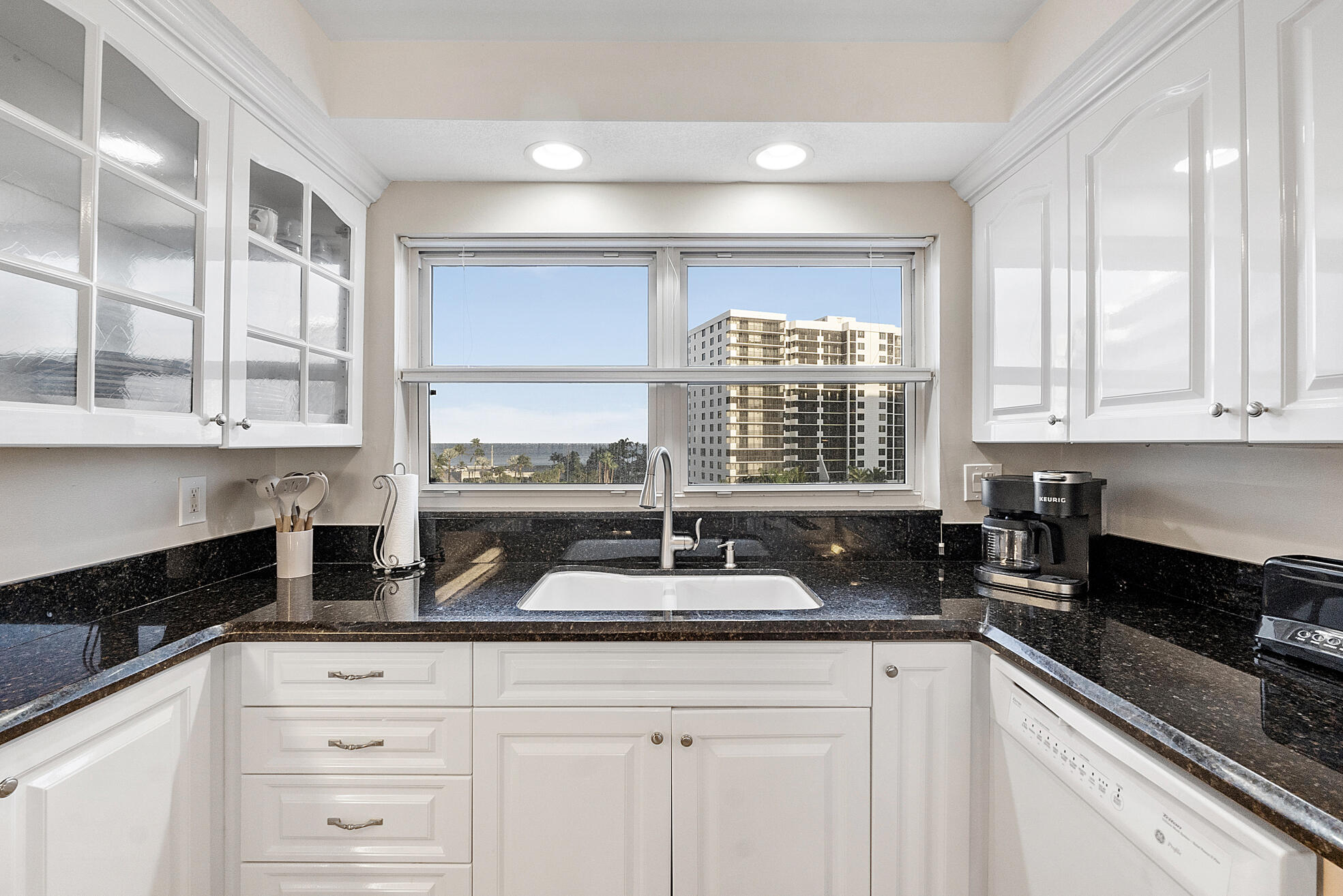 3310 South Ocean Boulevard, Unit 629D Highland Beach, FL 33487 - Photo 5 of 35 a kitchen with granite countertop white cabinets and a window