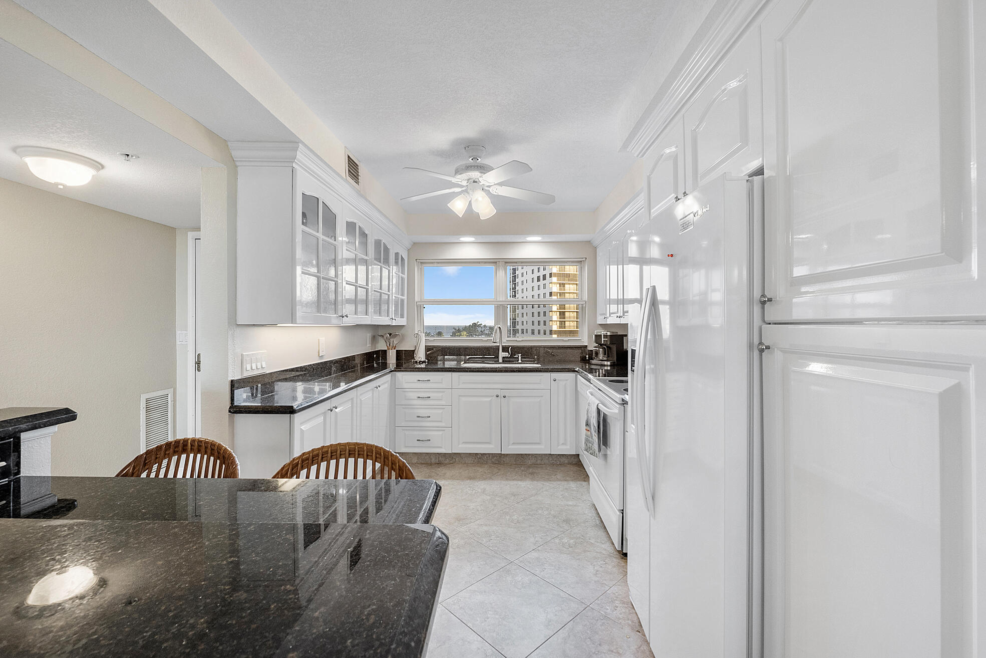 3310 South Ocean Boulevard, Unit 629D Highland Beach, FL 33487 - Photo 6 of 35 a kitchen with refrigerator a sink and cabinets