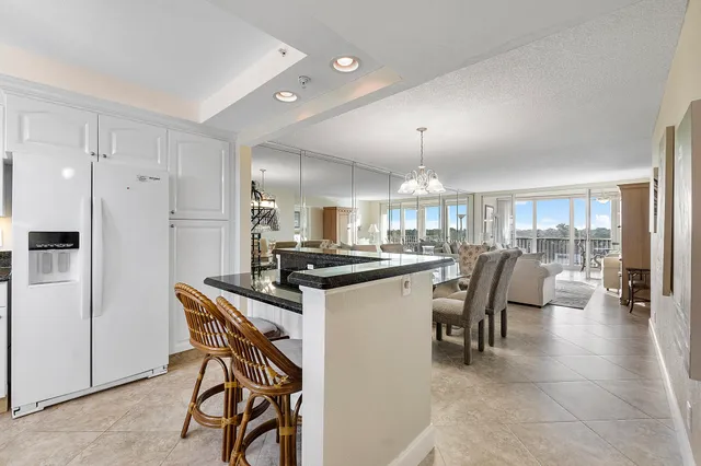 a kitchen with a table chairs refrigerator and microwave