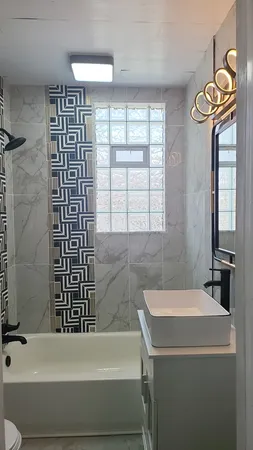 a bathroom with a bathtub and a shower