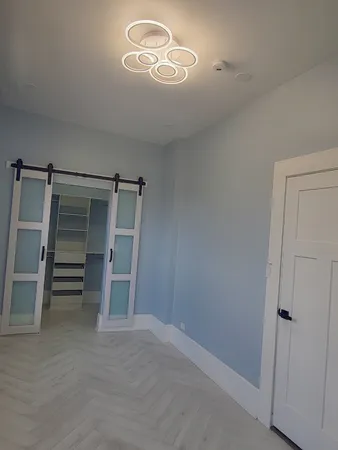 a view of an empty room with a cabinet