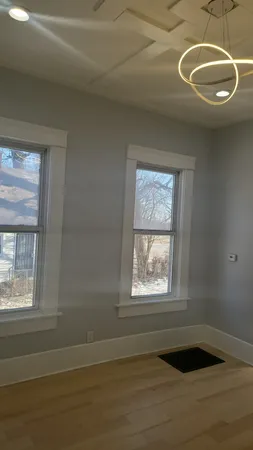 a view of a livingroom with wooden floor and window