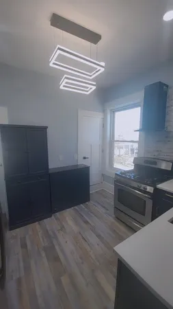 a kitchen with wooden cabinets and a stove