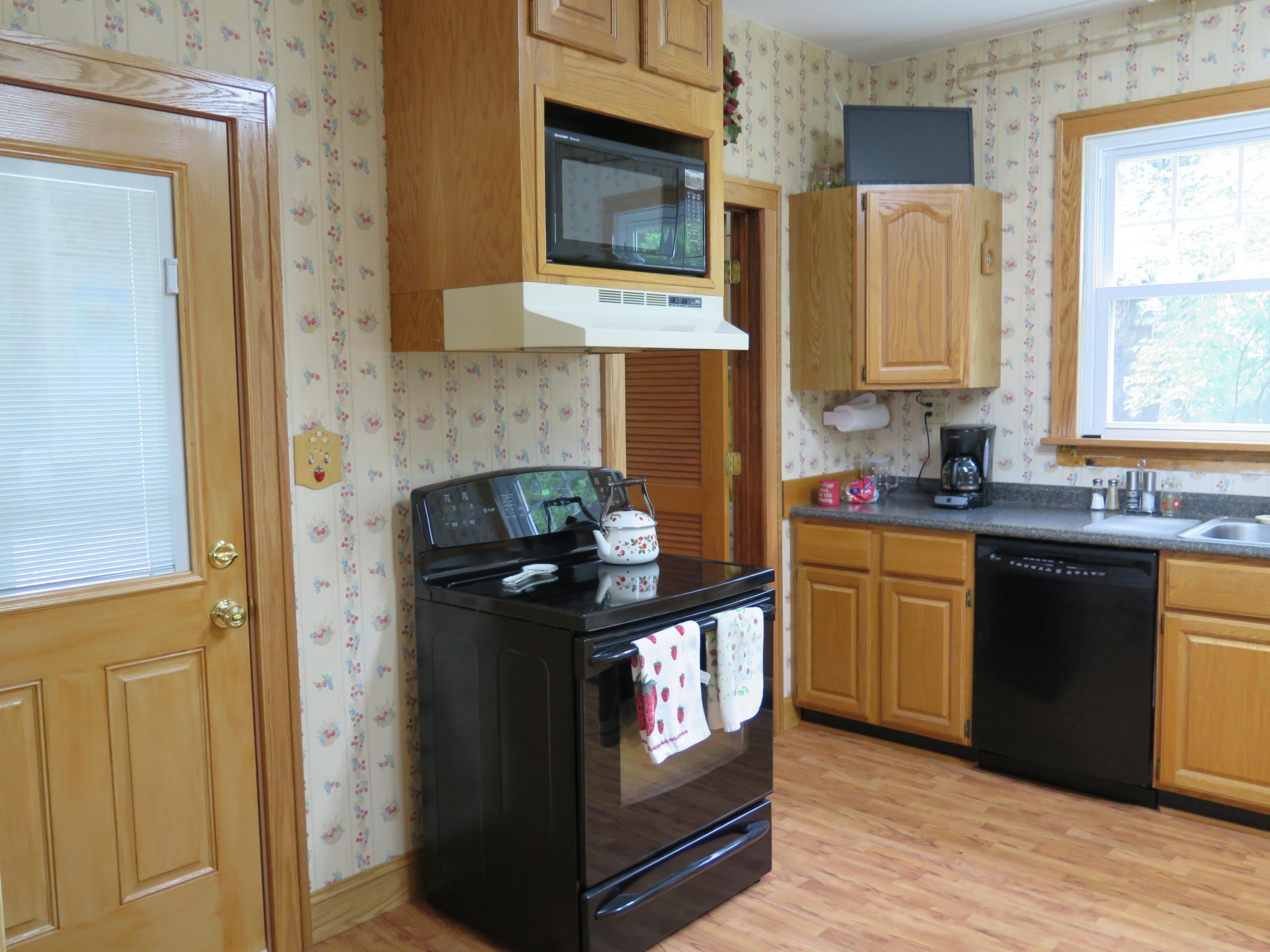 2315 Rutrough Road Southeast Roanoke, VA 24014 - Photo 3 of 38 a kitchen with stainless steel appliances granite countertop a stove a sink and a refrigerator