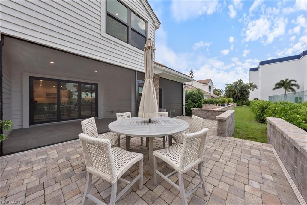 569 Park Shore Drive, Unit G5 Naples, FL 34103 - Photo 12 of 45 a view of a patio with a table and chairs and potted plants