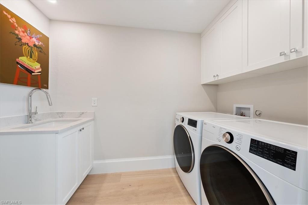 569 Park Shore Drive, Unit G5 Naples, FL 34103 - Photo 21 of 45 a utility room with dryer and washer