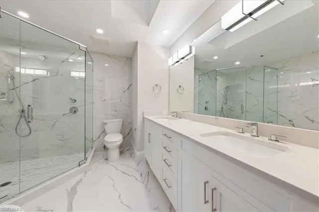 a spacious bedroom with a bed and a dresser