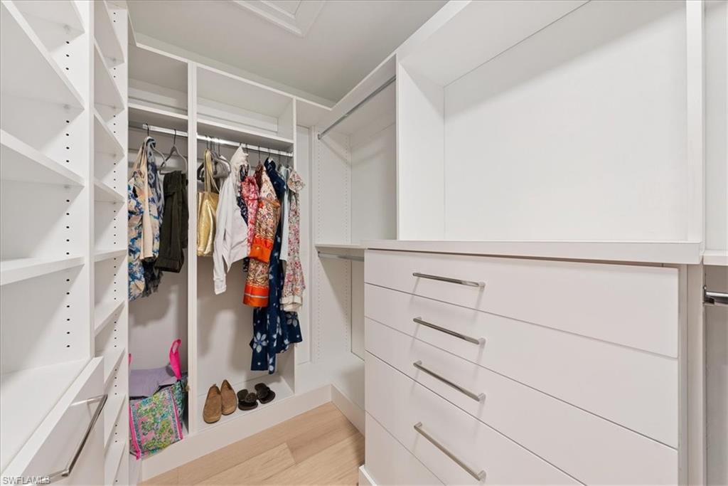 569 Park Shore Drive, Unit G5 Naples, FL 34103 - Photo 28 of 45 a view of walk in closet with clothes and shoes