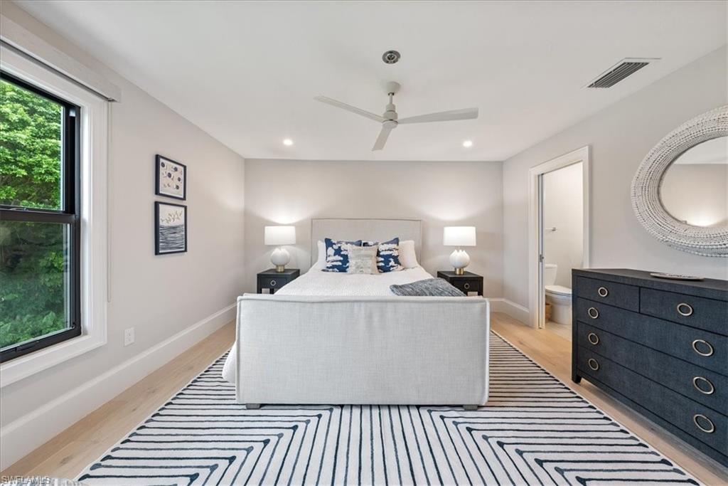 569 Park Shore Drive, Unit G5 Naples, FL 34103 - Photo 29 of 45 a spacious bedroom with a bed and a dresser