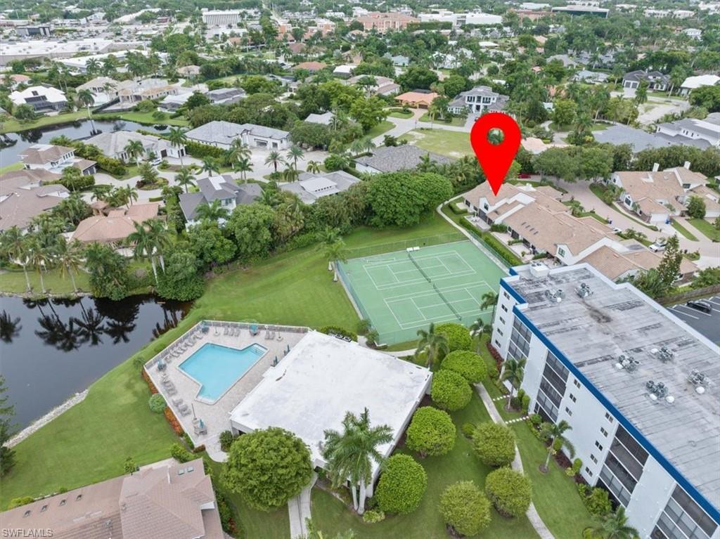 569 Park Shore Drive, Unit G5 Naples, FL 34103 - Photo 36 of 45 a view of a wooden house with a yard and potted plants
