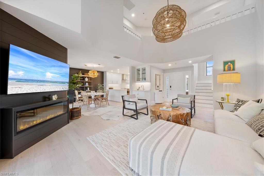 569 Park Shore Drive, Unit G5 Naples, FL 34103 - Photo 7 of 45 a living room with furniture and a flat screen tv