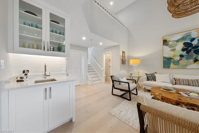 a living room with furniture and a kitchen