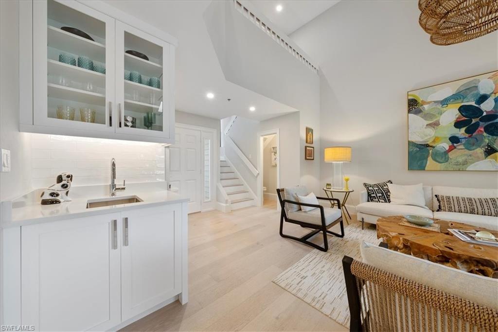 569 Park Shore Drive, Unit G5 Naples, FL 34103 - Photo 8 of 45 a living room with furniture and a kitchen