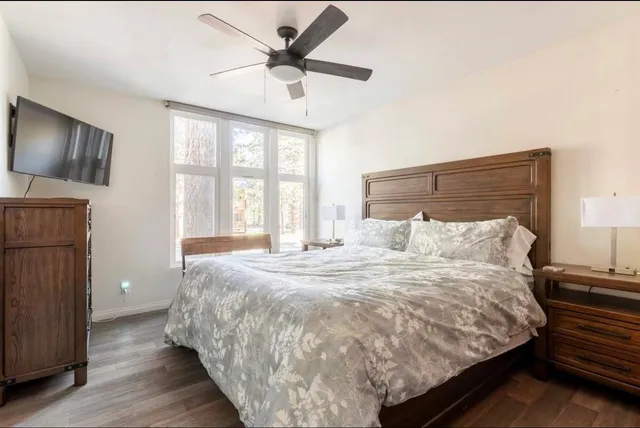 a large bed sitting in a bedroom next to a window