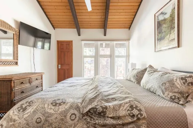 a bedroom with a large bed and a window