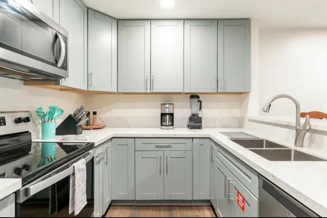 a kitchen with a sink cabinets and stainless steel appliances