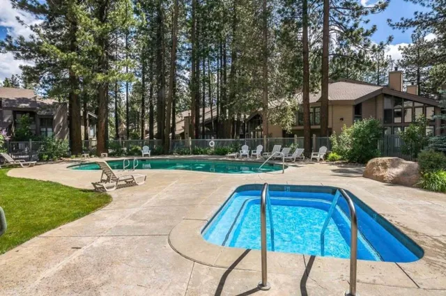 a swimming pool with outdoor seating and yard
