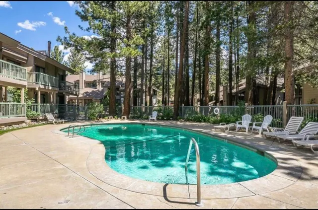 a swimming pool with outdoor seating and yard