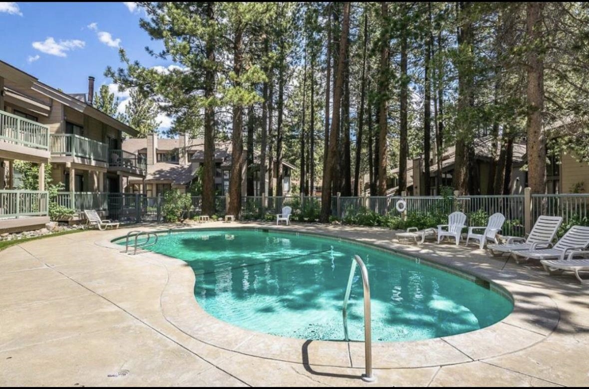2252 Meridian Boulevard, Unit 39 Mammoth Lakes, CA 93546 - Photo 29 of 32 a swimming pool with outdoor seating and yard