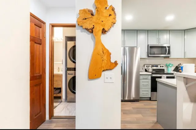 a kitchen with stainless steel appliances a refrigerator and a stove