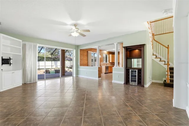 a room with stainless steel appliances a refrigerator a sink dishwasher a stove and a refrigerator with wooden floor