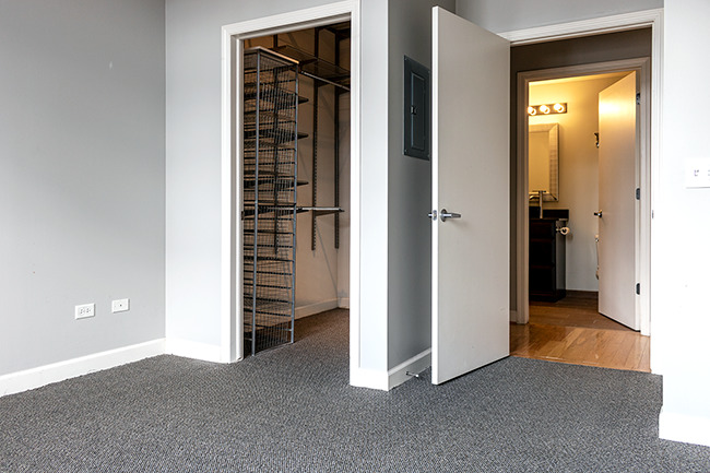 111 South Morgan Street, Unit 824 Chicago, IL 60607 - Photo 13 of 18 an empty room with closet and a bathroom