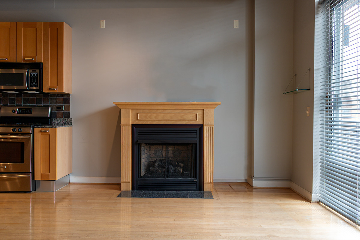 111 South Morgan Street, Unit 824 Chicago, IL 60607 - Photo 6 of 18 a living room with furniture a fireplace and a window