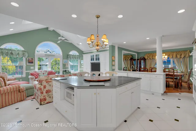 a kitchen with stainless steel appliances granite countertop a sink a stove a refrigerator and cabinets