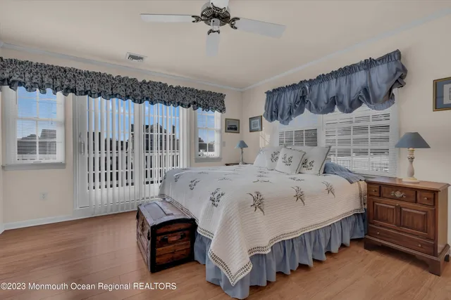 a bedroom with a bed a dresser and a window