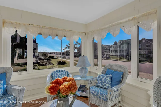 a living room with furniture and a floor to ceiling window
