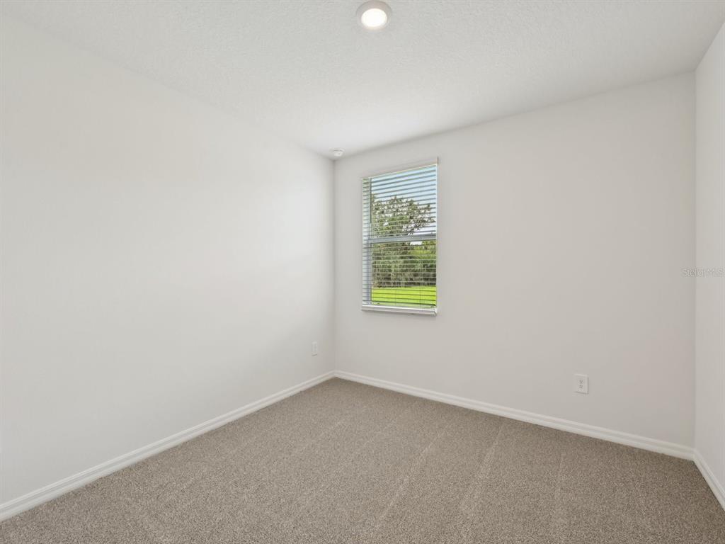 7628 Satterfield Terrace Parrish, FL 34219 - Photo 19 of 25 an empty room with a window