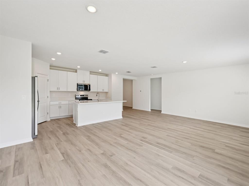 7628 Satterfield Terrace Parrish, FL 34219 - Photo 4 of 25 a view of kitchen with wooden floor