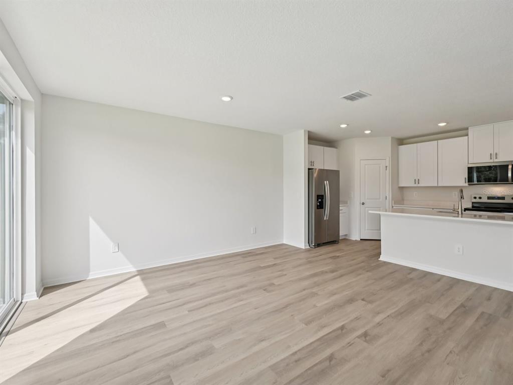 7628 Satterfield Terrace Parrish, FL 34219 - Photo 5 of 25 a view of a kitchen with a sink and a refrigerator