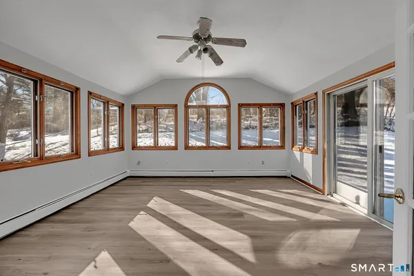 wooden floor in an empty room with a window