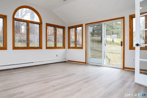 a view of an empty room with wooden floor
