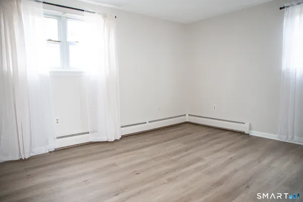 a view of a ceiling fan with wooden floor and a ceiling fan