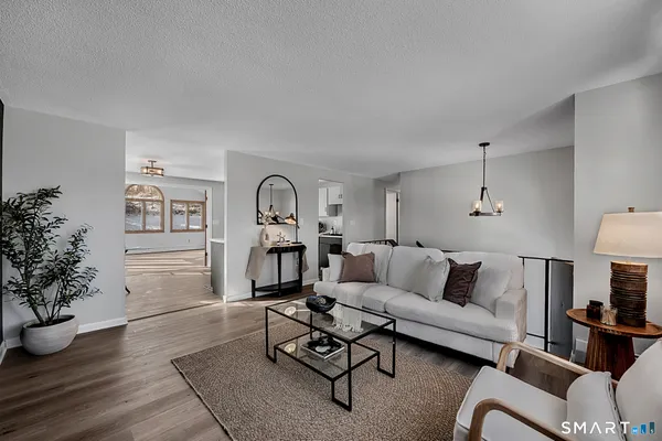 a kitchen with stainless steel appliances granite countertop a stove top oven a sink dishwasher and a refrigerator