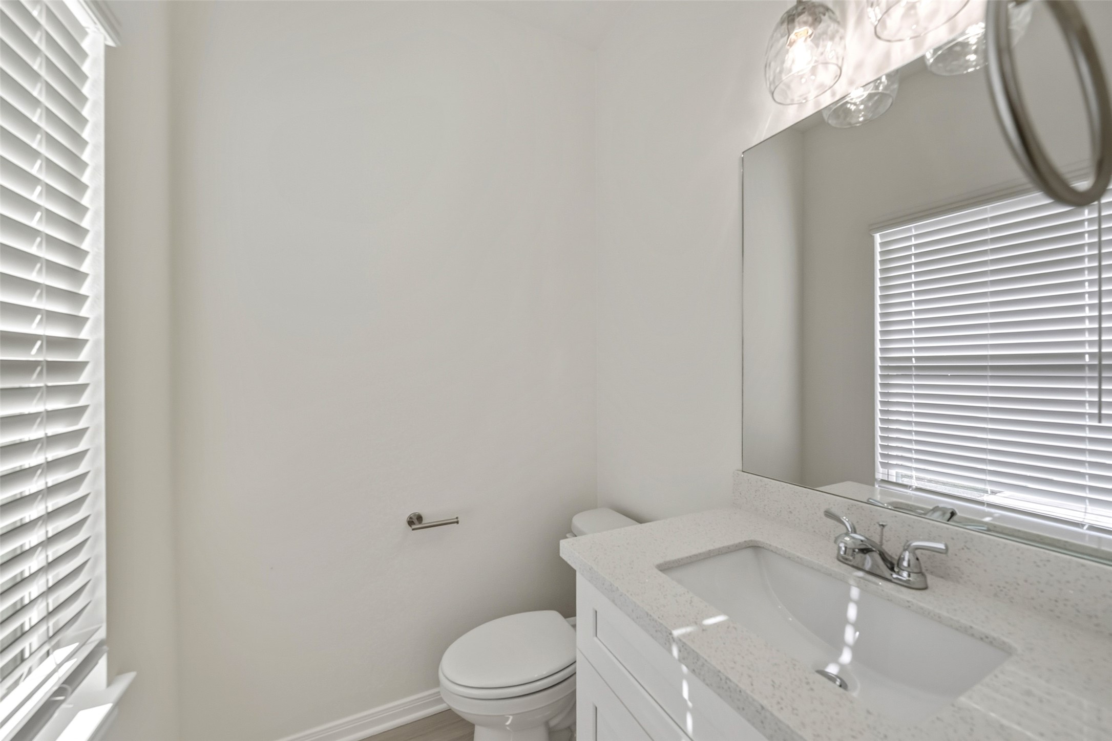716 West Dallas Street Conroe, TX 77301 - Photo 15 of 24 a bathroom with a sink a toilet and a mirror