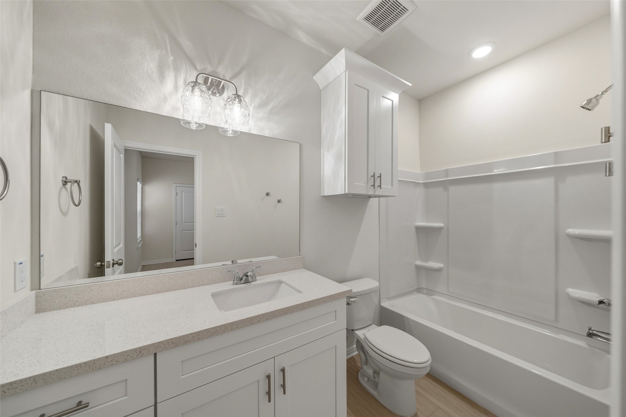 716 West Dallas Street Conroe, TX 77301 - Photo 17 of 24 a bathroom with a sink a toilet a mirror and shower