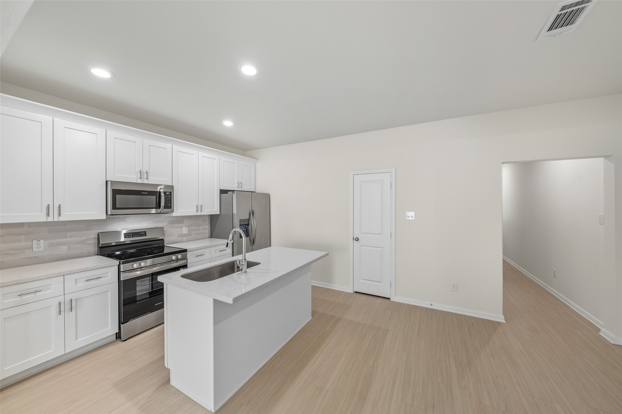 716 West Dallas Street Conroe, TX 77301 - Photo 9 of 24 a kitchen with white cabinets stainless steel appliances and a counter space