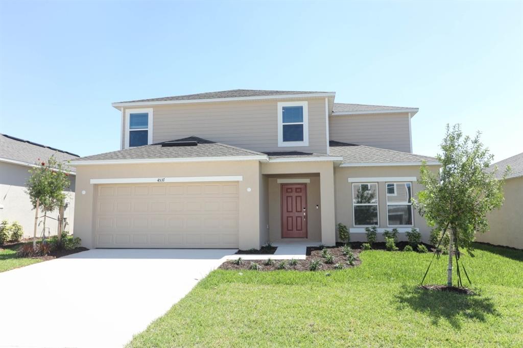 4537 Ranunculus St Lake Haines City, FL 33844 - Photo 1 of 1 a backyard of a house with yard and tree