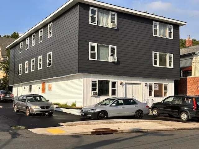 a view of a car parked in front of a house