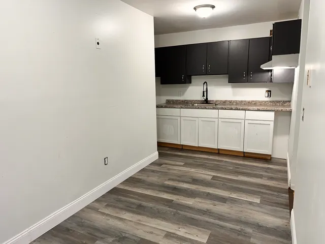 a kitchen with stainless steel appliances granite countertop a sink and a stove top oven