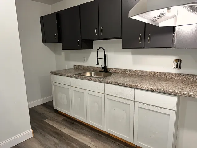 a kitchen with a sink and cabinets