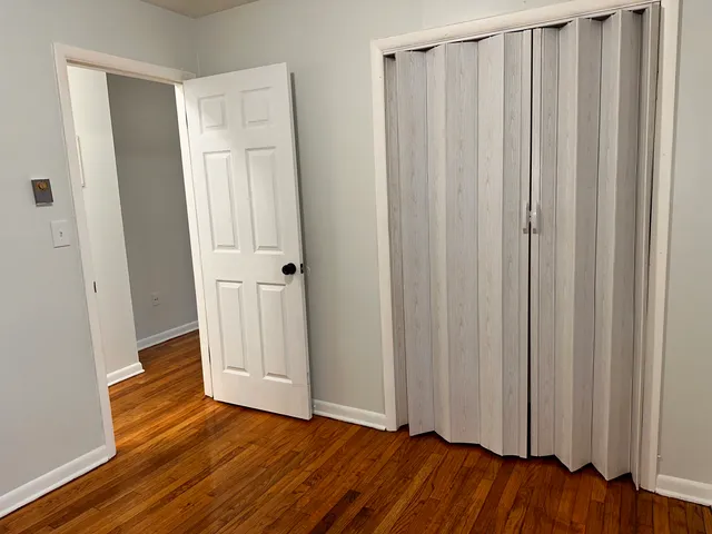 a view of a room with wooden floor