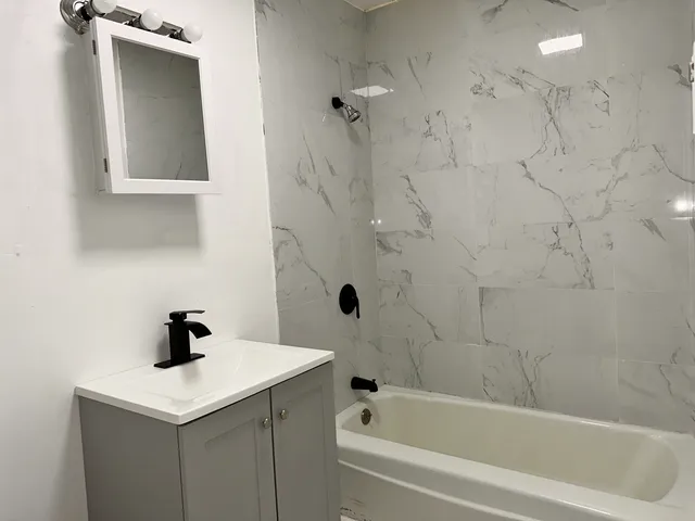 a bathroom with a sink a toilet and bathtub